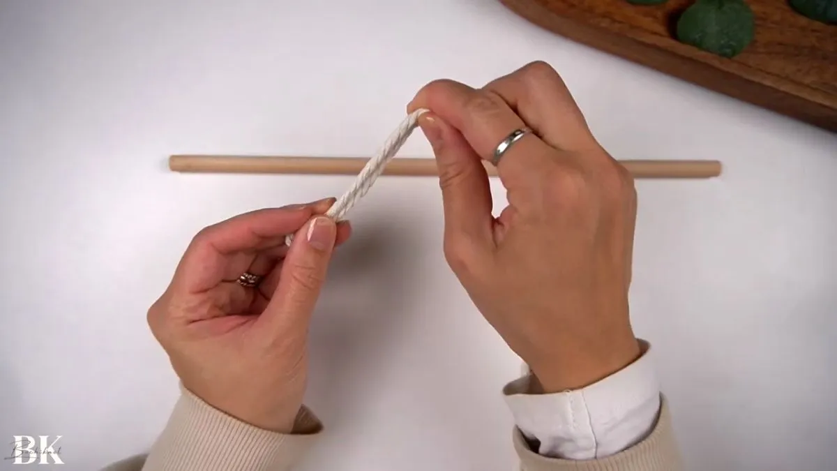 Attaching macrame cord to wooden dowel using a lark’s head knot